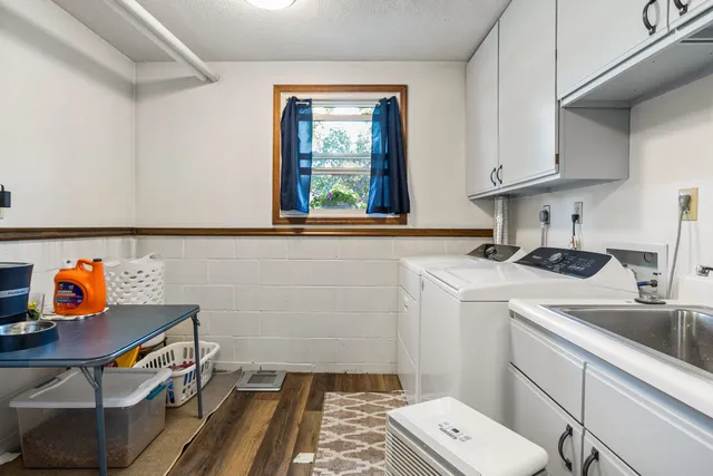 a utility room with sink dryer and washer