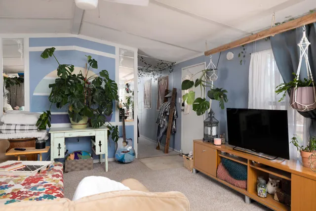 a living room with furniture and a flat screen tv