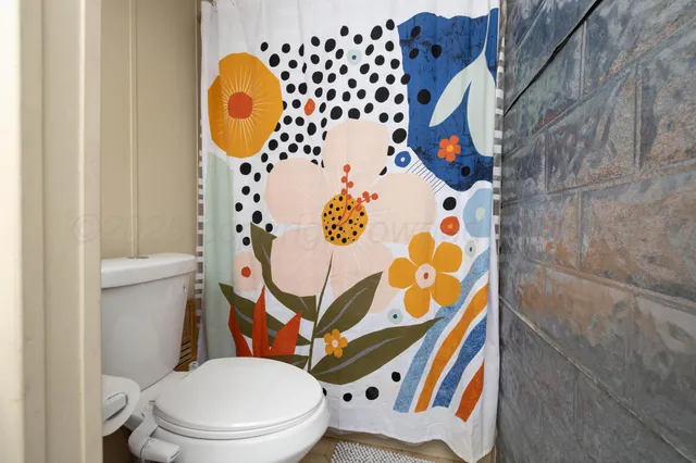 a bathroom with a sink mirror vanity and toilet