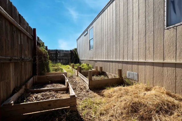 a kitchen with a stove and a wooden cabinets