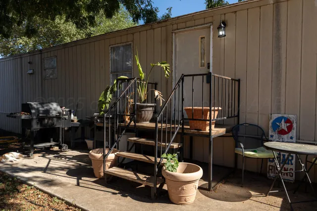 a backyard of a house with table and chairs