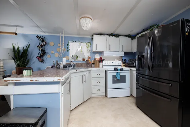 a kitchen with a refrigerator and a sink