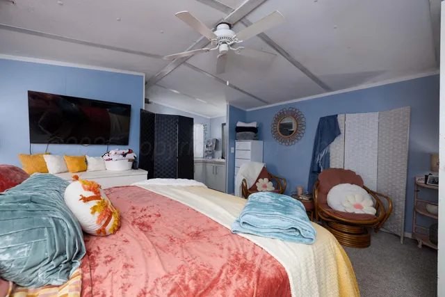 a bedroom with a bed and a flat screen tv