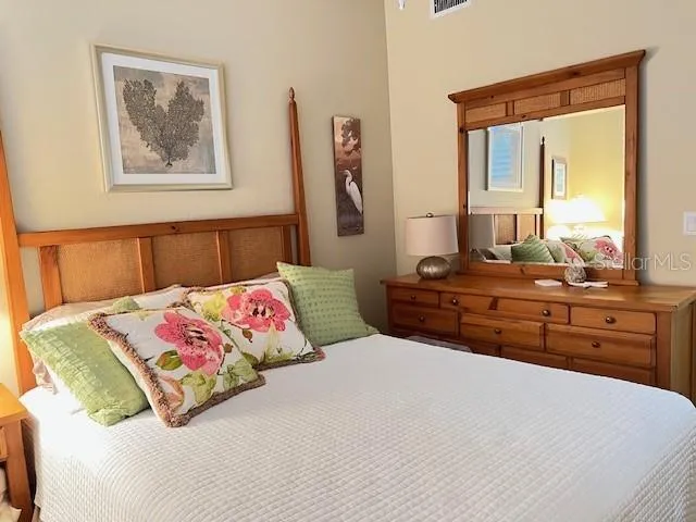 a bedroom with a bed and dresser