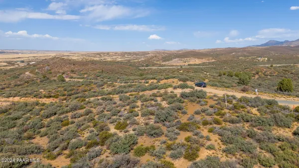 a view of a field with an ocean