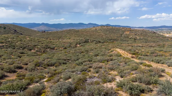 a view of a large building with a yard in the background