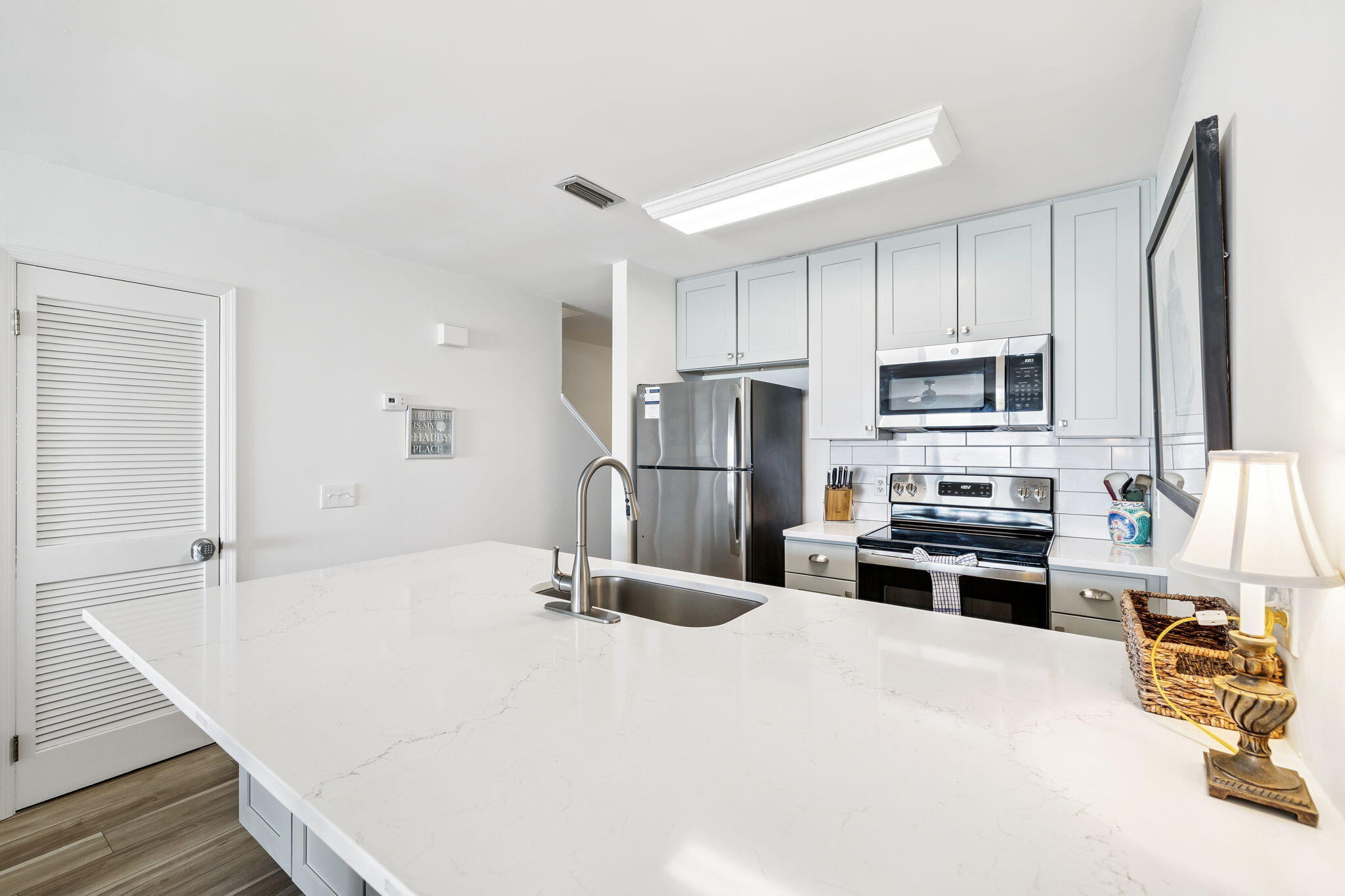 8116 East County Highway 30A, Unit 5 Inlet Beach, FL 32461 - Photo 13 of 48 a kitchen with stainless steel appliances a refrigerator sink stove microwave and cabinets