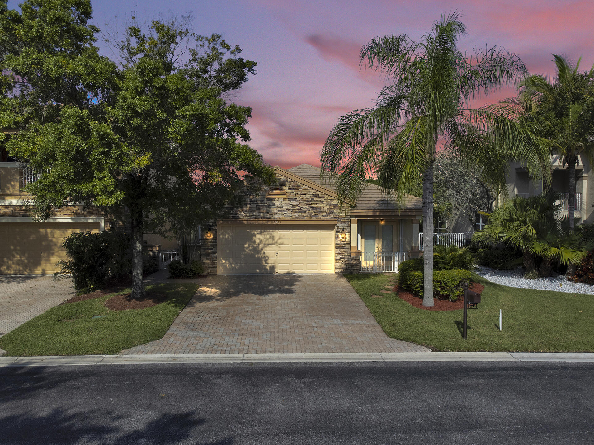 5803 Raceway Road Lake Worth, FL 33449 - Photo 1 of 49 front view of a house with a yard and potted plants