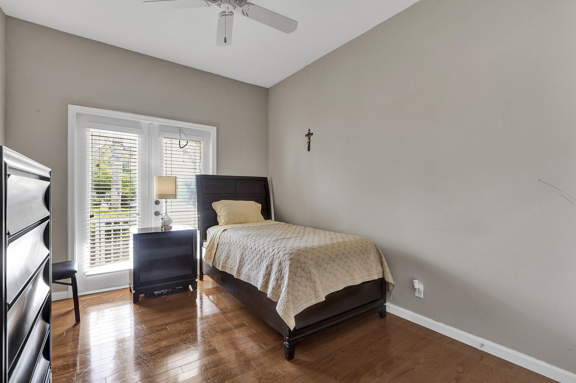 5803 Raceway Road Lake Worth, FL 33449 - Photo 23 of 49 a bedroom with a bed and a flat tv screen on dresser