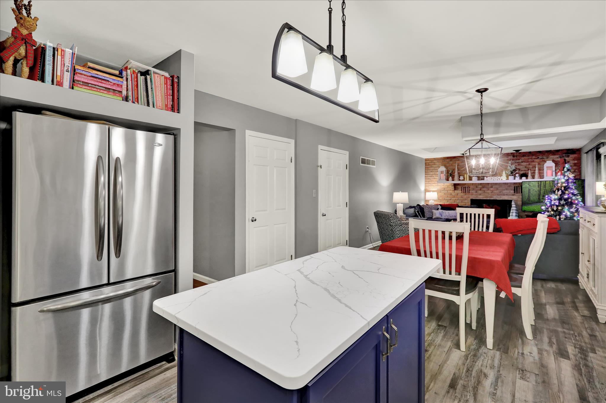 314 Fairview Road Reading, PA 19606 - Photo 11 of 45 a open kitchen with stainless steel appliances kitchen island granite countertop a dining table chairs and a refrigerator