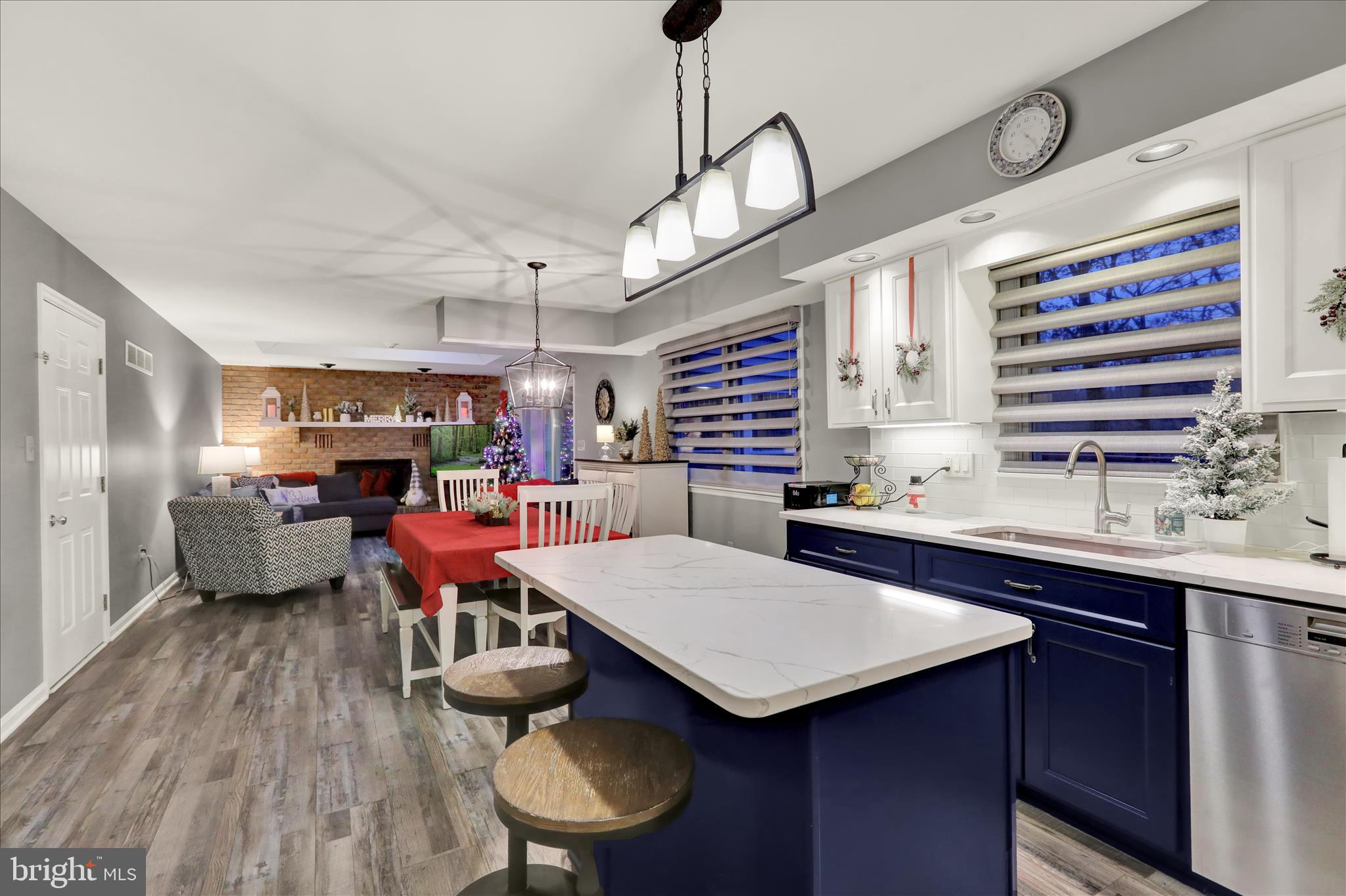 314 Fairview Road Reading, PA 19606 - Photo 12 of 45 a kitchen with stainless steel appliances a table chairs in it and wooden floors