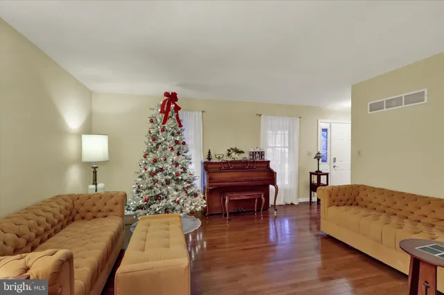 a living room with furniture and a christmas tree