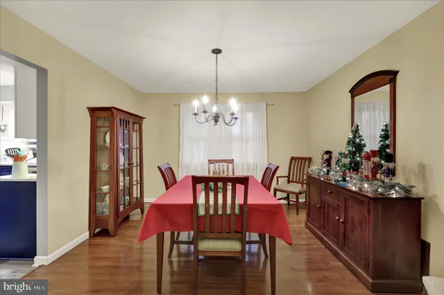 a view of a dining room with furniture and chandelier