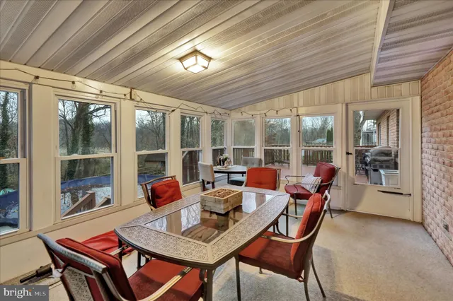 a dining room with furniture wooden floor and a chandelier