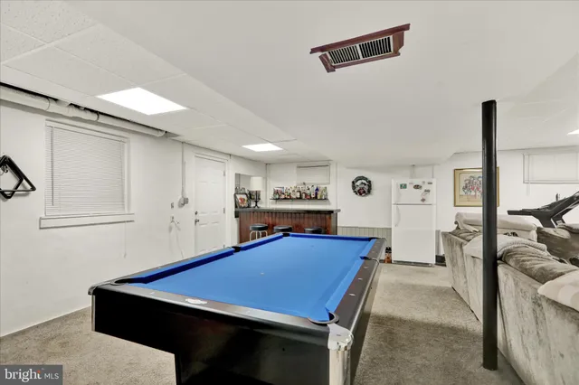 a room with furniture and pool table