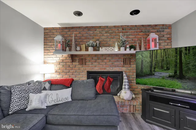 a living room with furniture and a fireplace