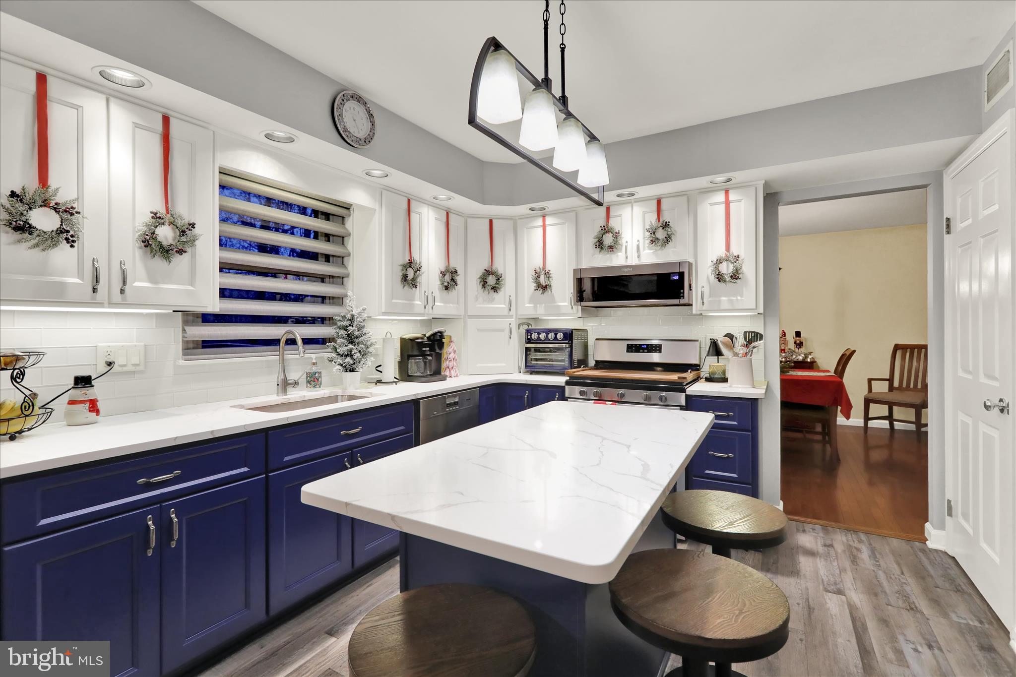 314 Fairview Road Reading, PA 19606 - Photo 9 of 45 a kitchen with stainless steel appliances granite countertop a stove a sink dishwasher a dining table and chairs with wooden floor