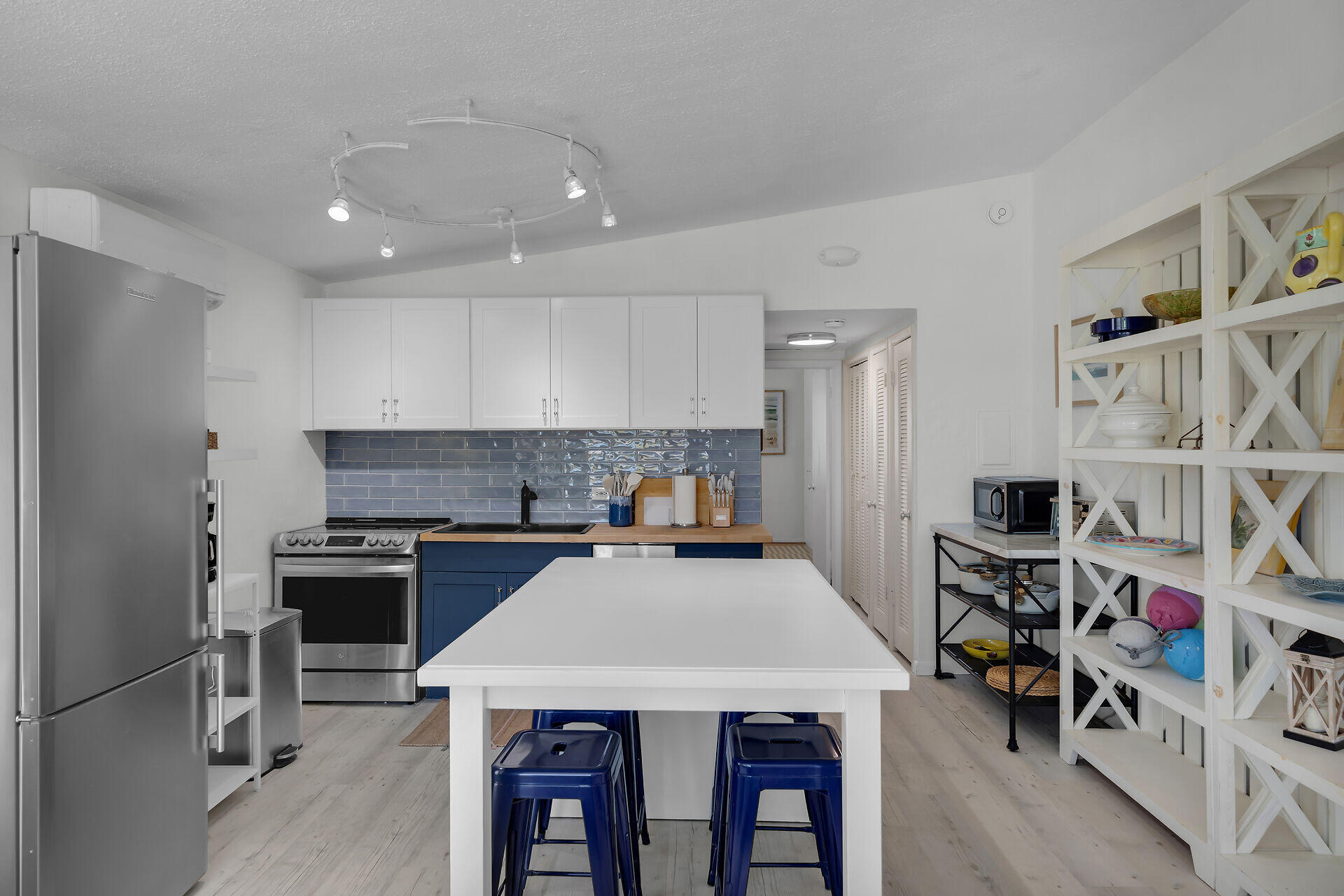 10 Clara Boulevard Marathon, FL 33051 - Photo 7 of 25 a kitchen with a stove a refrigerator and a dining table with wooden floor