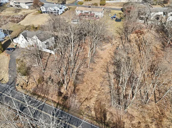 an aerial view of residential houses with city view