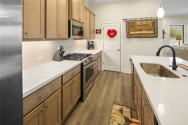 a kitchen with stainless steel appliances granite countertop a stove and a sink