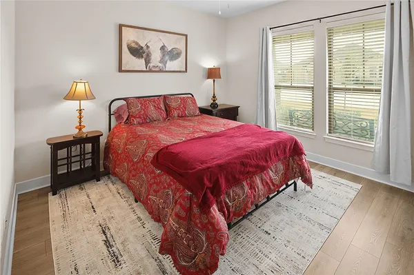 a bedroom with a bed and a night stand