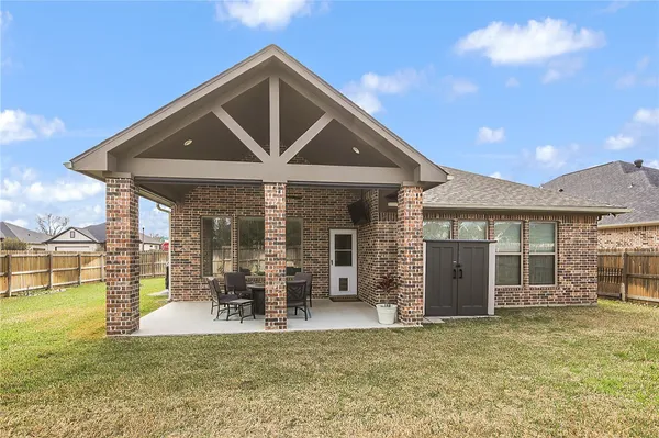 a front view of a house with a yard outdoor seating and barbeque oven