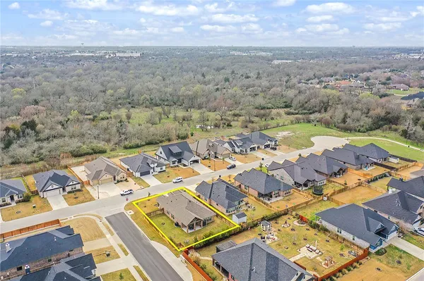 an aerial view of a house with a big yard