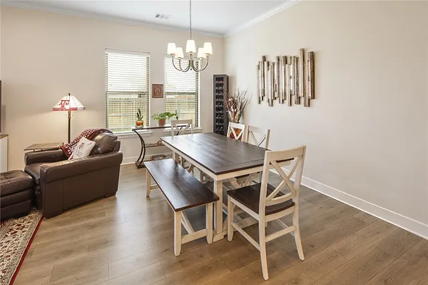 a living room with furniture a window and a chandelier