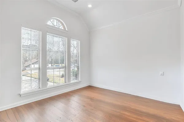 an empty room with a cabinet and mirrors