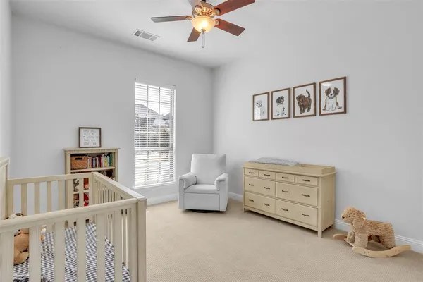 a living room with furniture and a ceiling fan