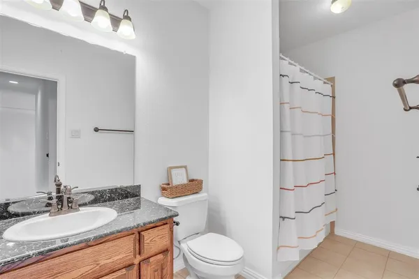 a living room with furniture a flat screen tv and a table