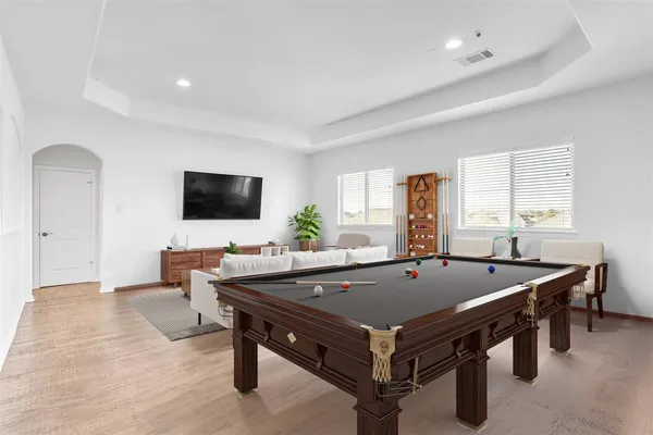 a dining room with furniture and large windows