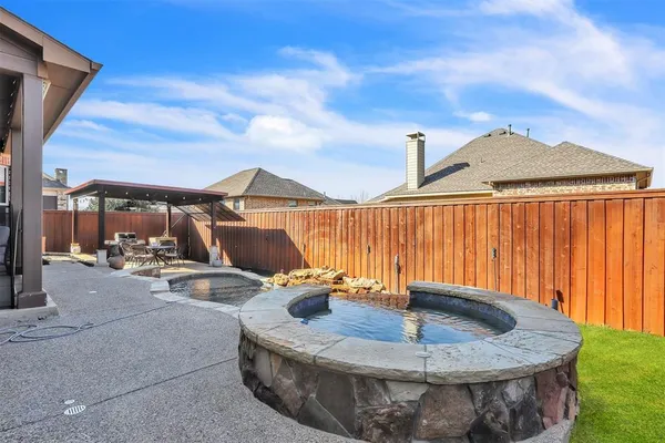 an aerial view of a house with a mountain