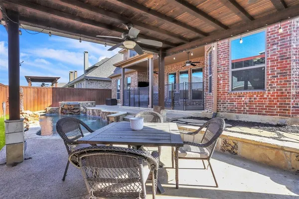 a view of a backyard with table and chairs with wooden floor
