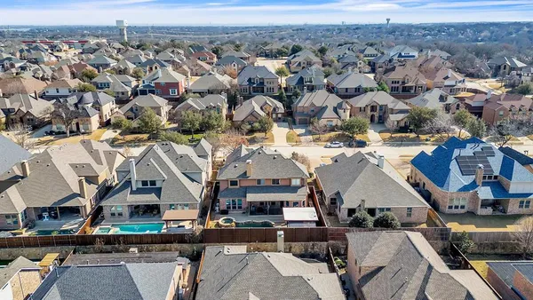 an aerial view of a building with parking spaces