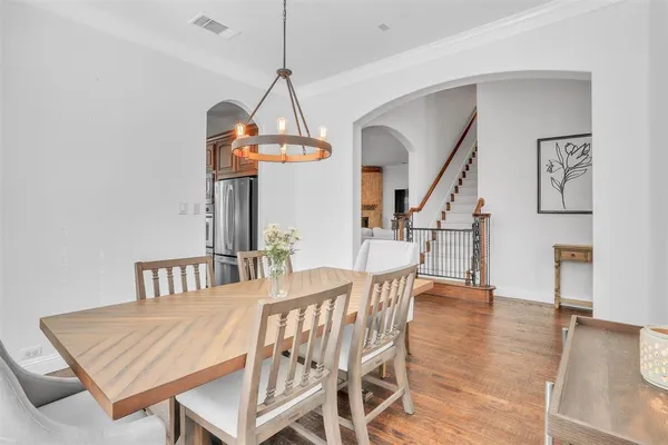 a view of a dining room with furniture wooden floor and chandelier