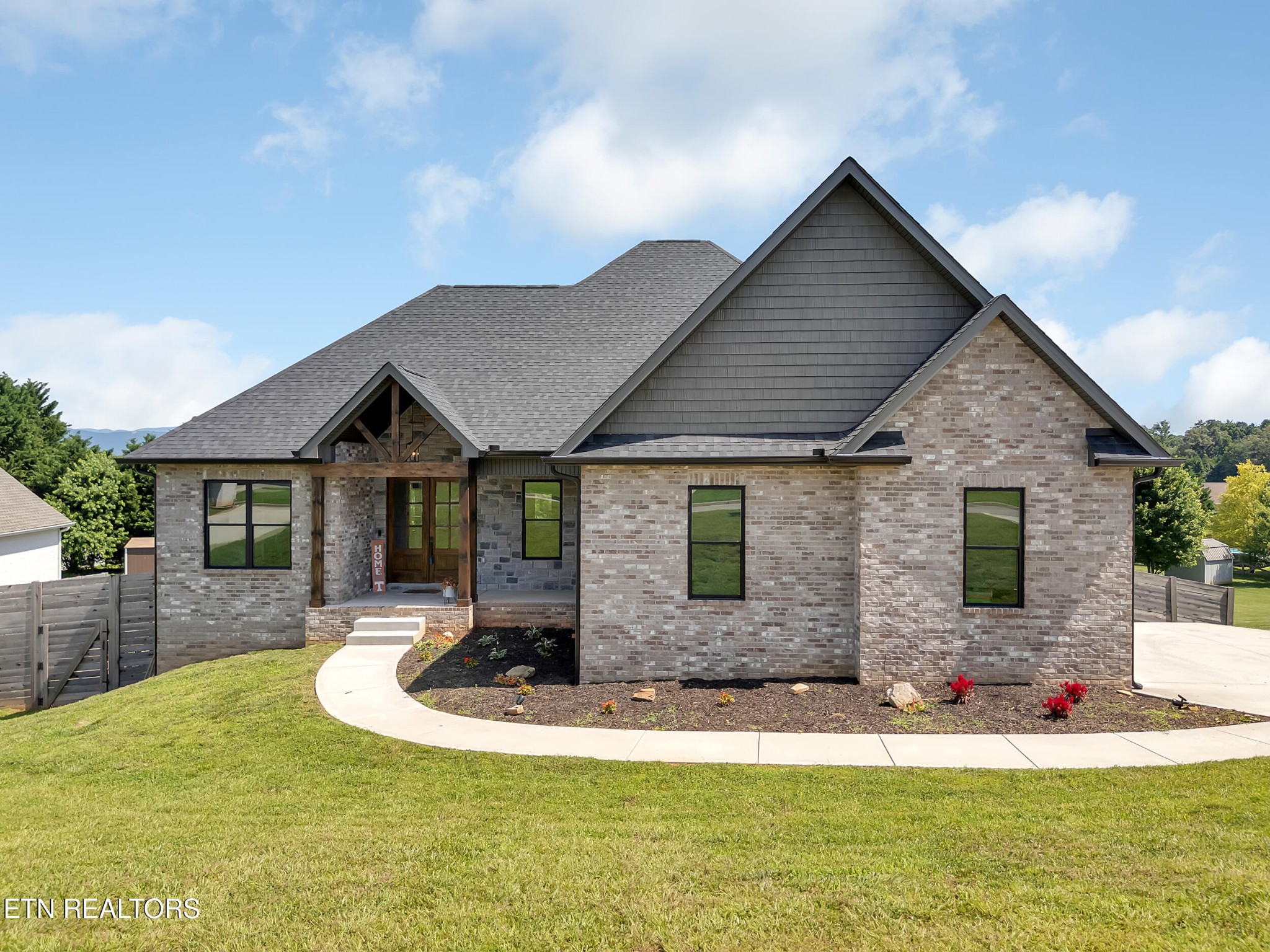 1216 Houston Springs Road Greenback, TN 37742 - Photo 2 of 57 a front view of house with yard and trees in the background