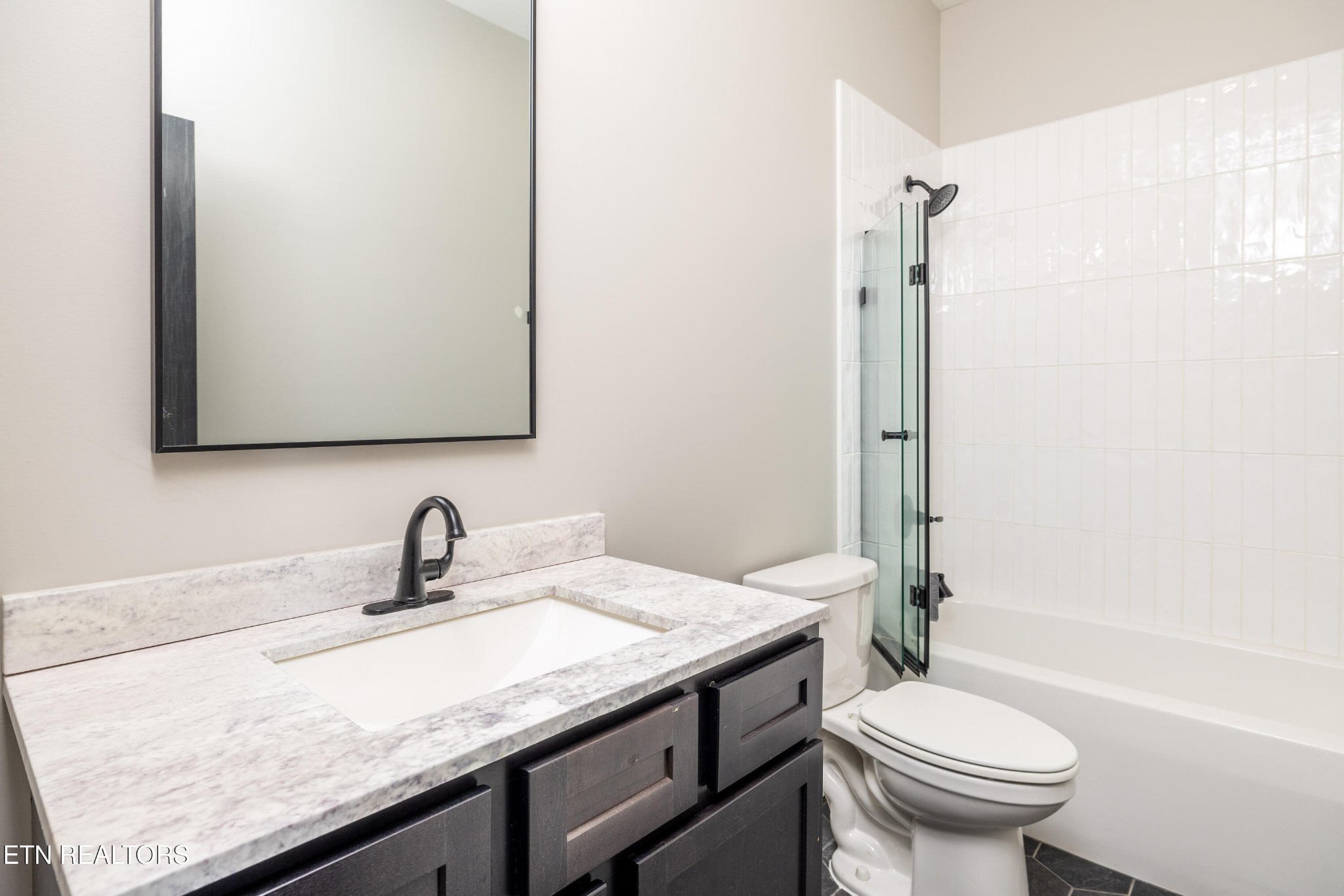 1216 Houston Springs Road Greenback, TN 37742 - Photo 40 of 57 a bathroom with a granite countertop sink a toilet and a mirror