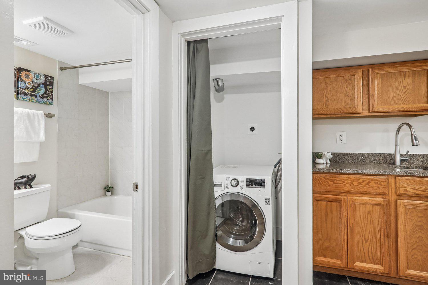911 L Street Northeast Washington, DC 20002 - Photo 40 of 48 a bathroom with a toilet sink and mirror