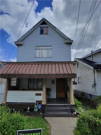 a front view of a house with stairs and garage
