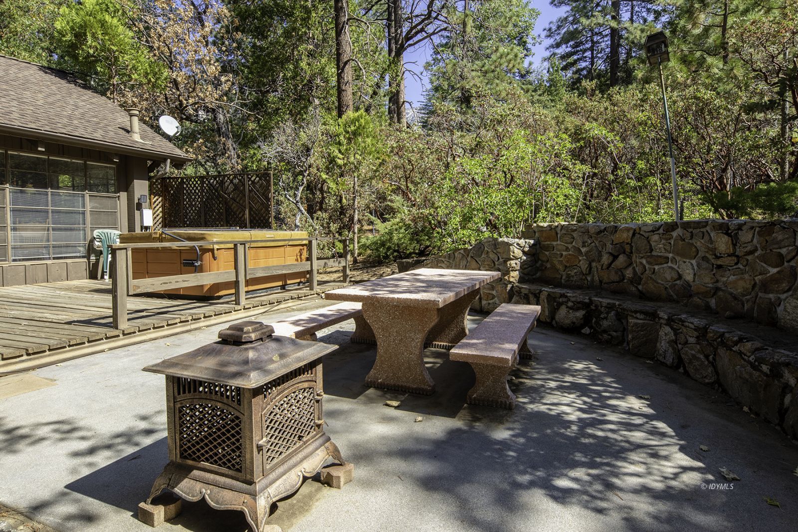 25180 Glen Road Idyllwild, CA 92549 - Photo 37 of 45 a view of a patio with table and chairs with wooden fence and plants