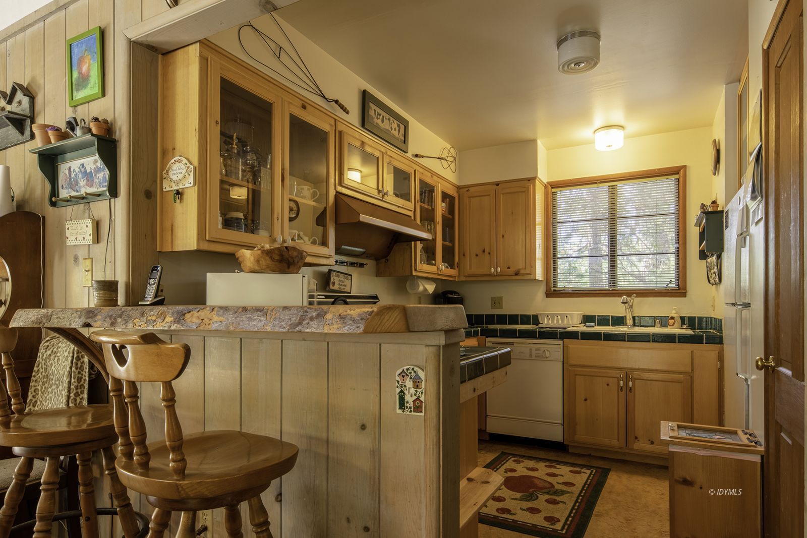 25180 Glen Road Idyllwild, CA 92549 - Photo 7 of 45 a kitchen with a sink a stove cabinets and a dining table