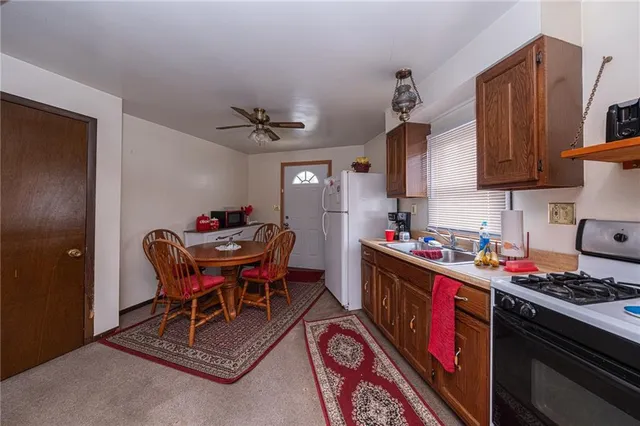a kitchen that has a table and chairs in it