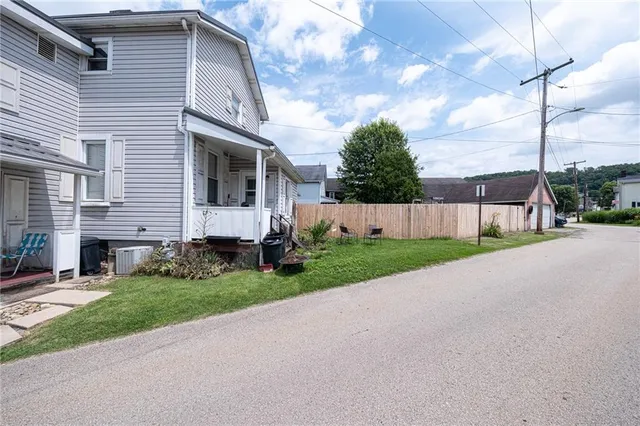 a view of a house with a yard and pathway