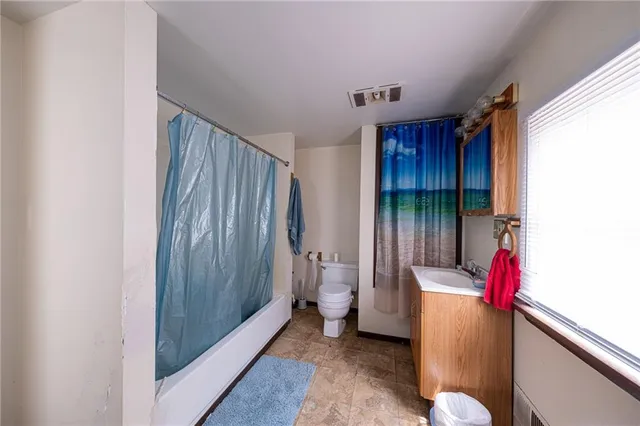 a hallway with toilet and shower