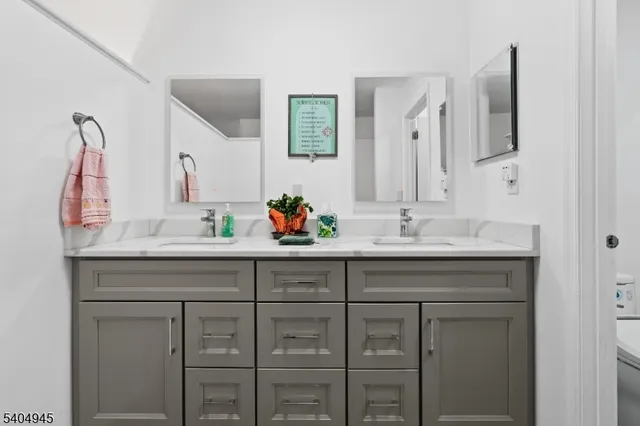 a bathroom with a sink vanity and mirror