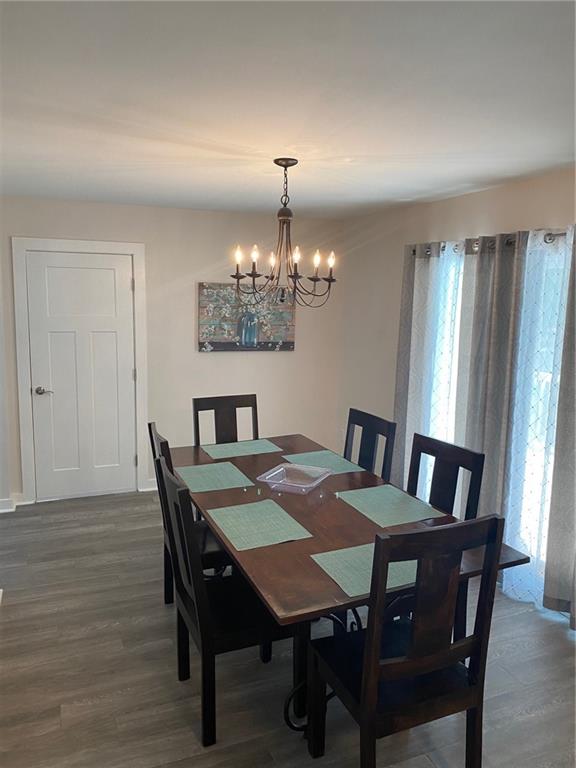 1608 Willie Drive Marietta, GA 30062 - Photo 14 of 35 a view of a dining room with furniture a chandelier and wooden floor