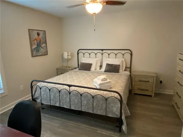a bedroom with a bed a chandelier and closet
