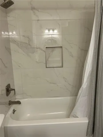 a bathroom with a shower and a tub