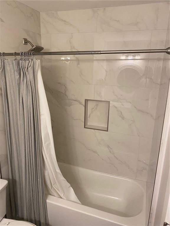 1608 Willie Drive Marietta, GA 30062 - Photo 26 of 35 a bathroom with a shower and a tub